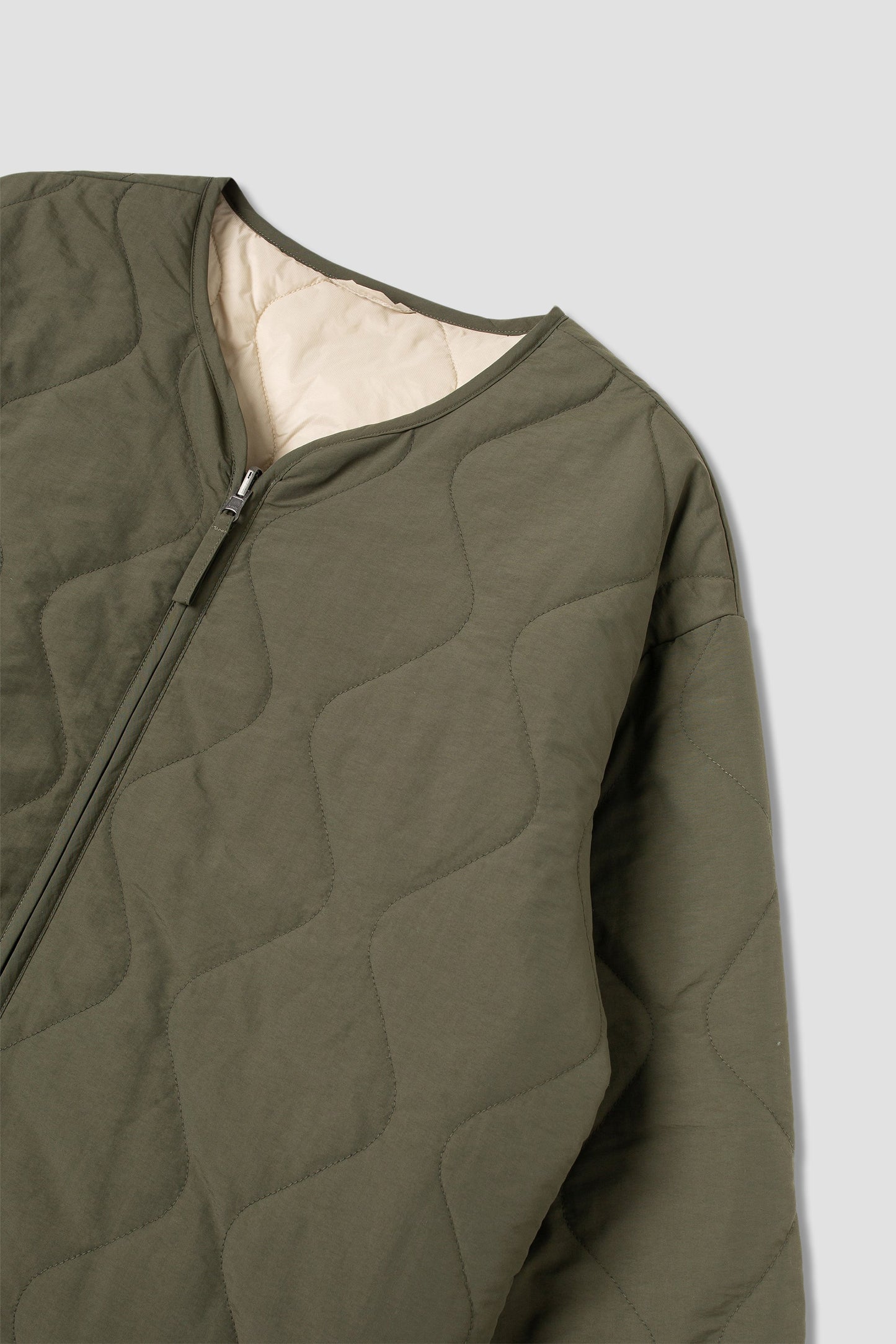 Side view of olive quilted liner jacket