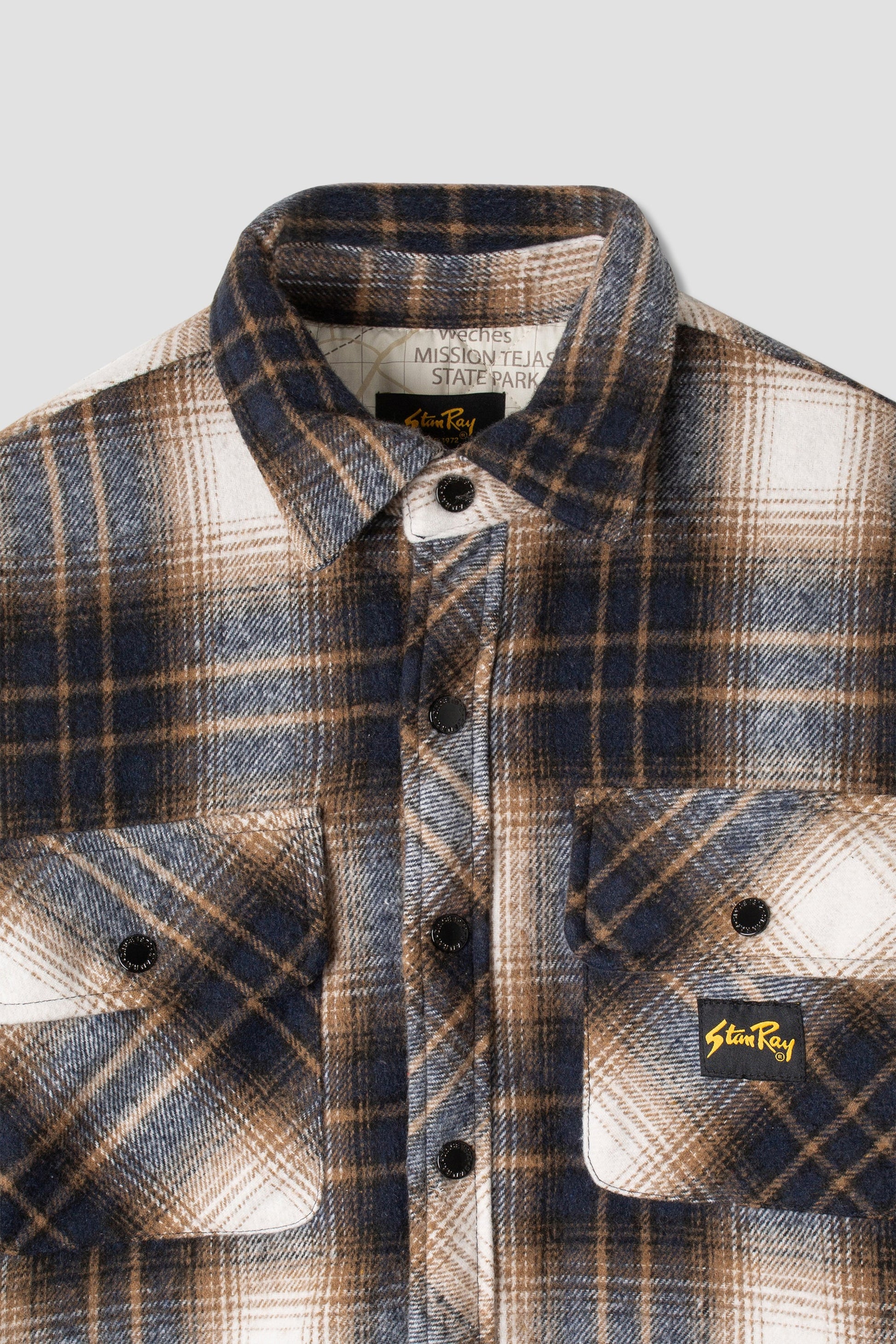 Close-up of front pockets on navy plaid overshirt