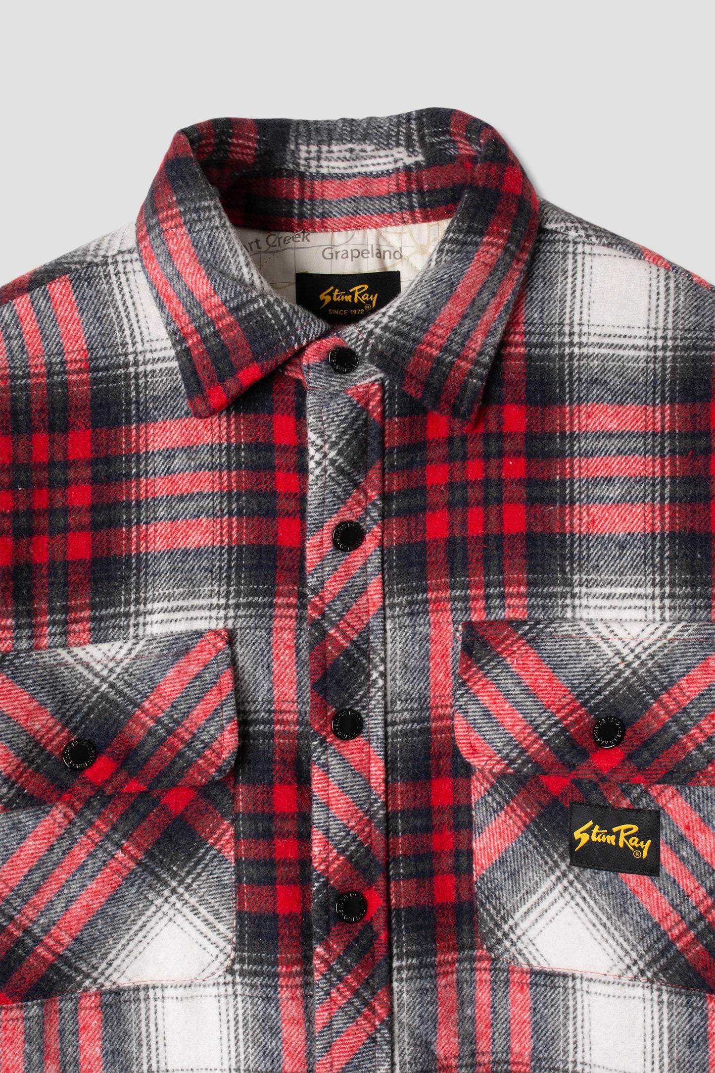 Close-up of Stan Ray Quilted Plaid Overshirt with logo