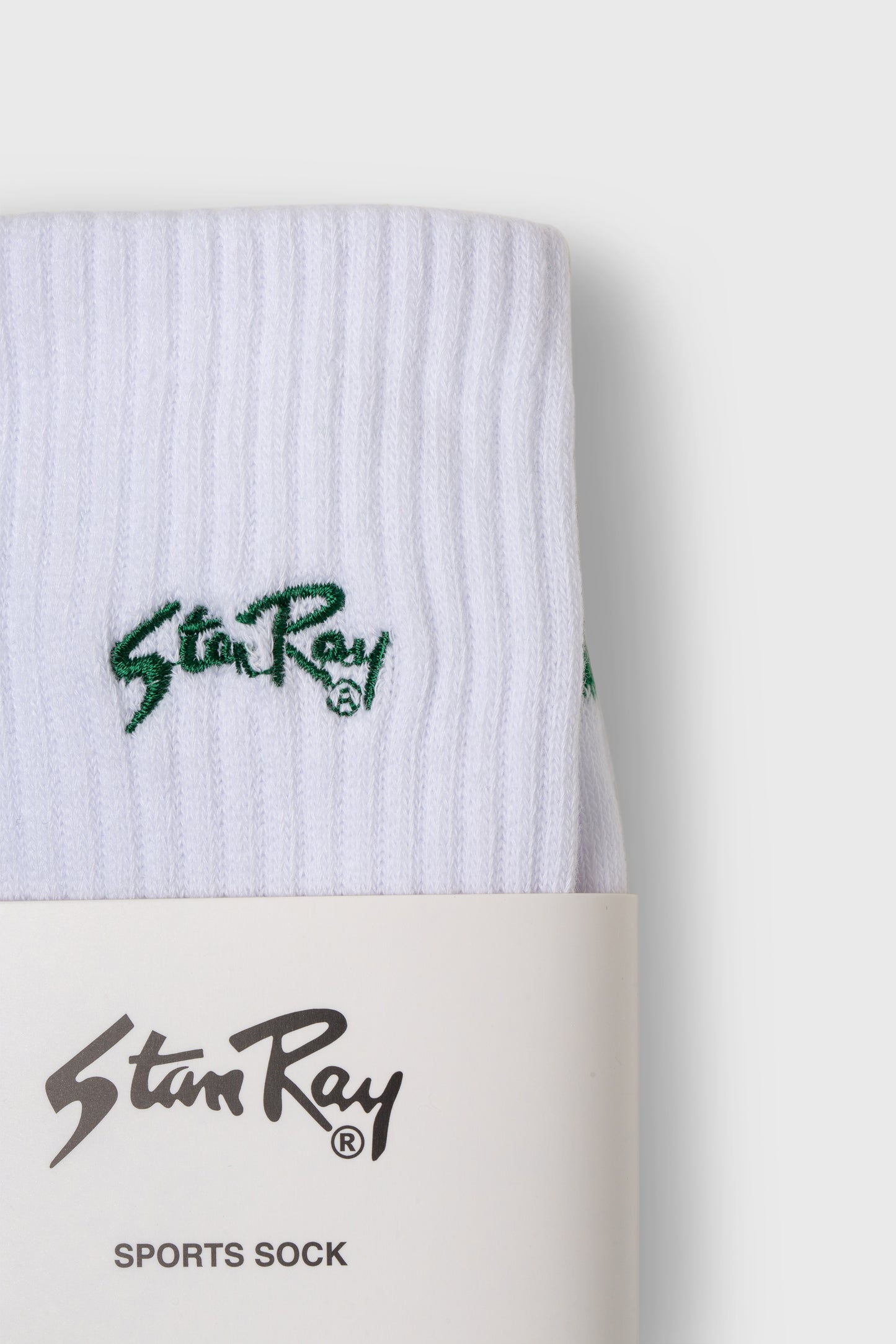 Close-up of Stan Ray logo on white sports sock