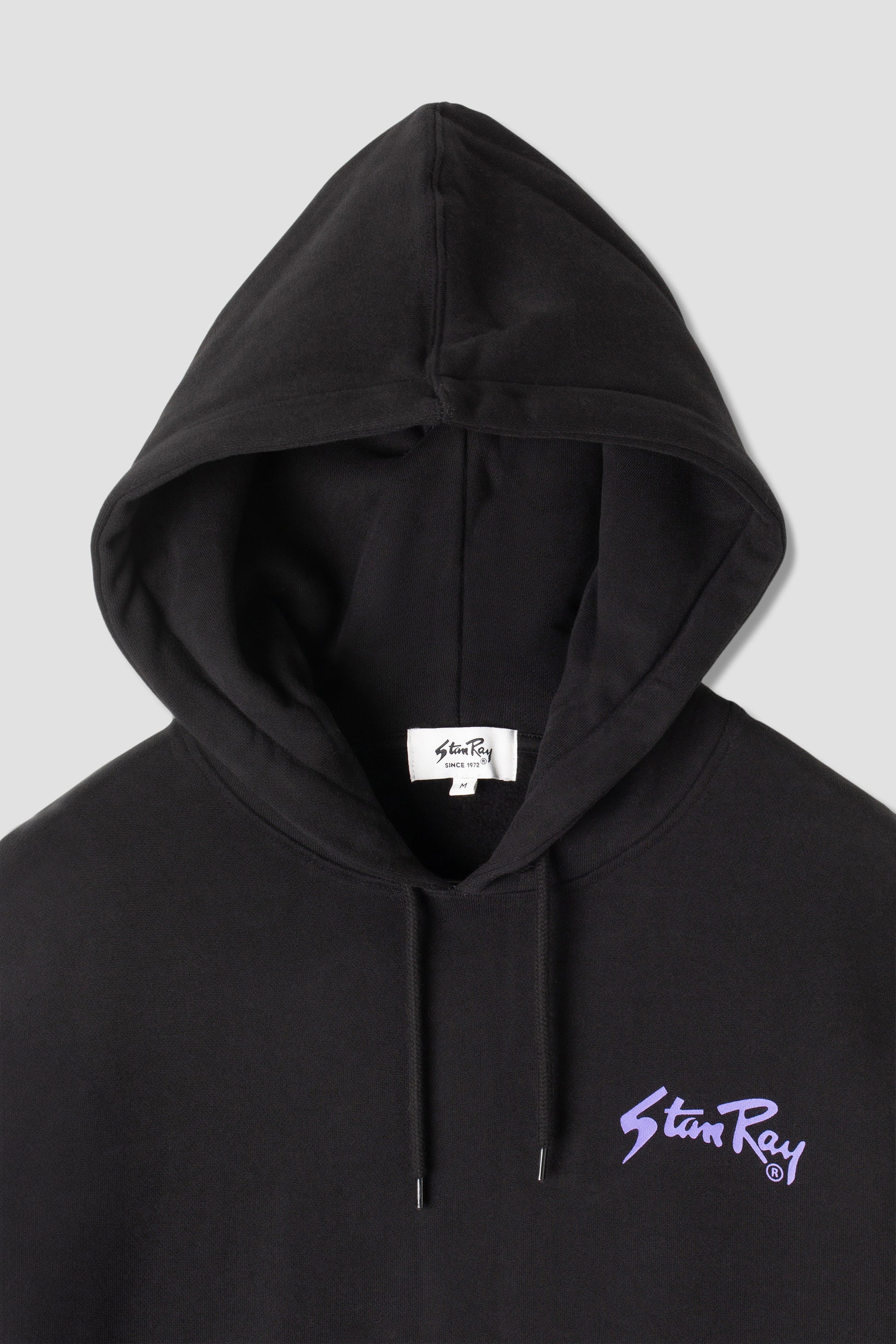 Close-up of Stan OG Hood hood and logo, black and purple