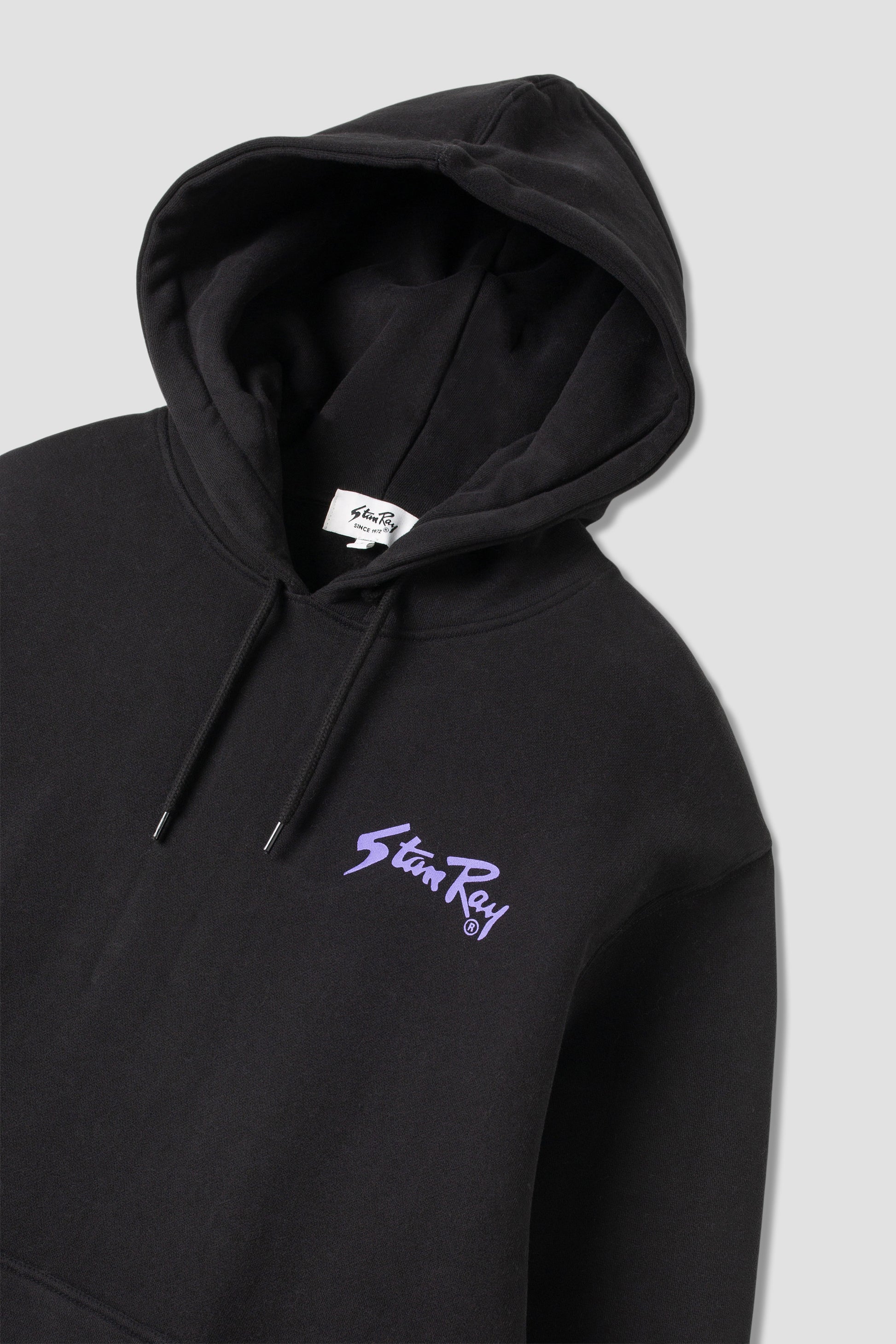 Stan OG Hood in black with purple logo, angled front view