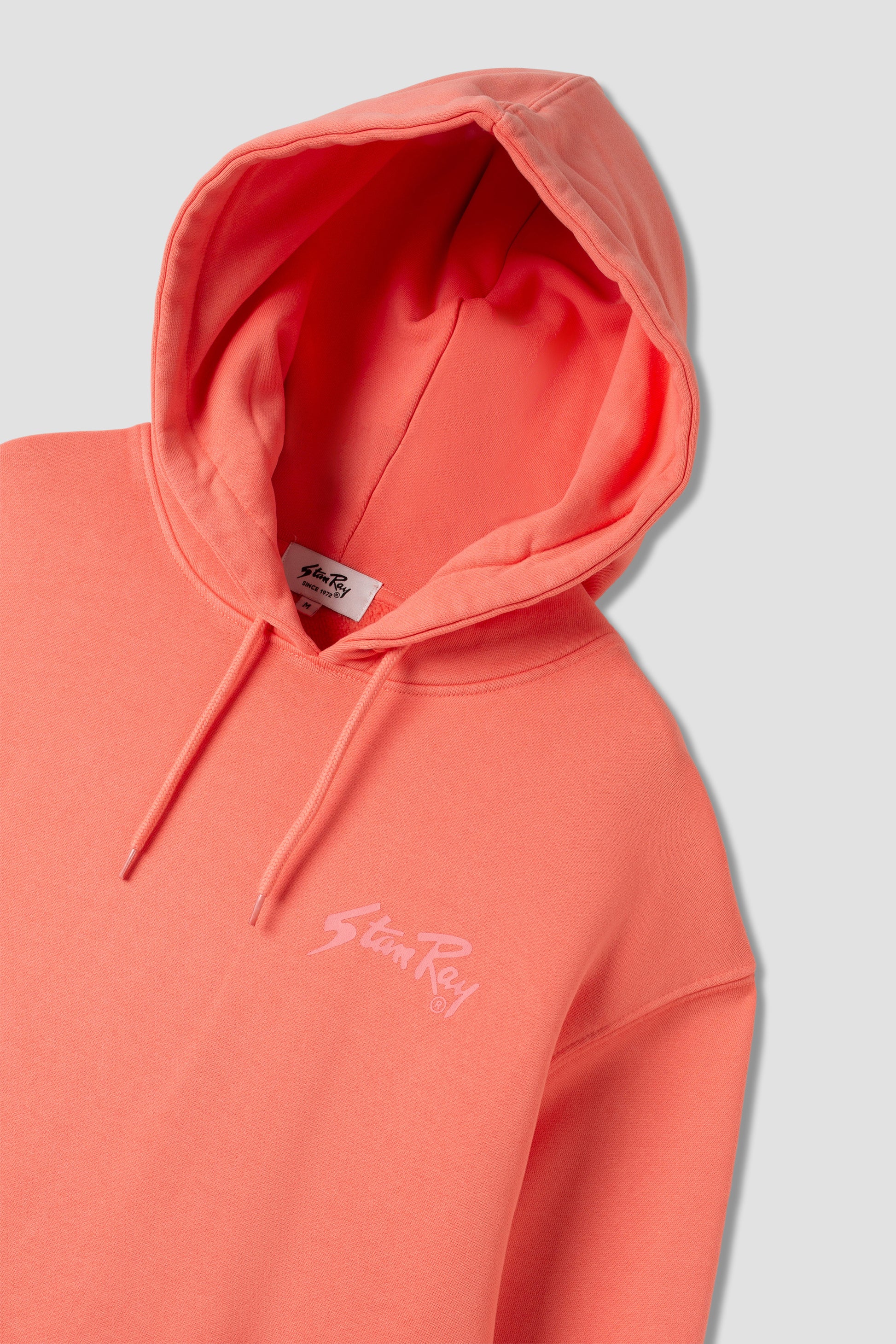 Angled view of Stan OG Hood in washed red with logo