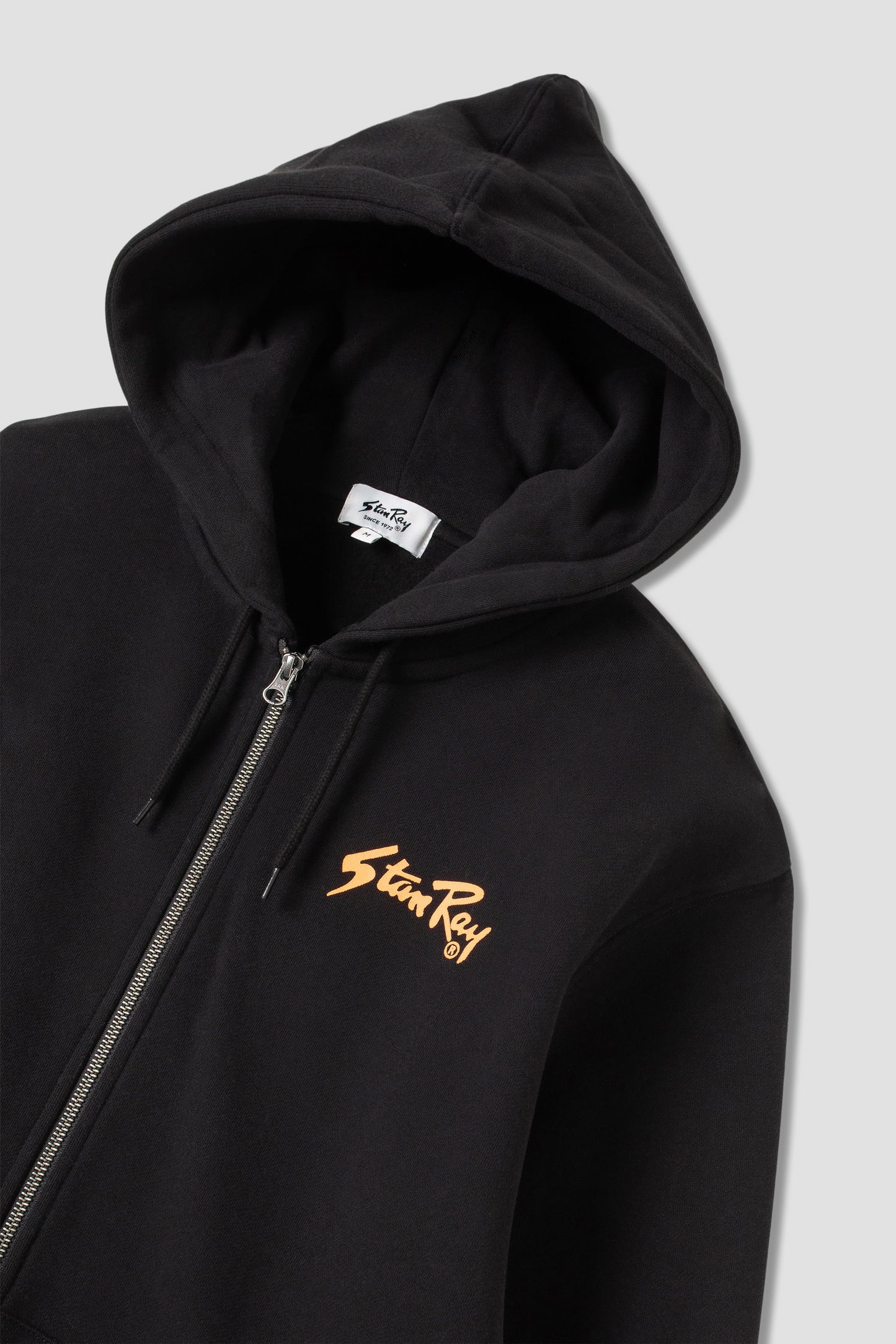 Angled view of Stan OG Zip Hood with orange Stan Ray print