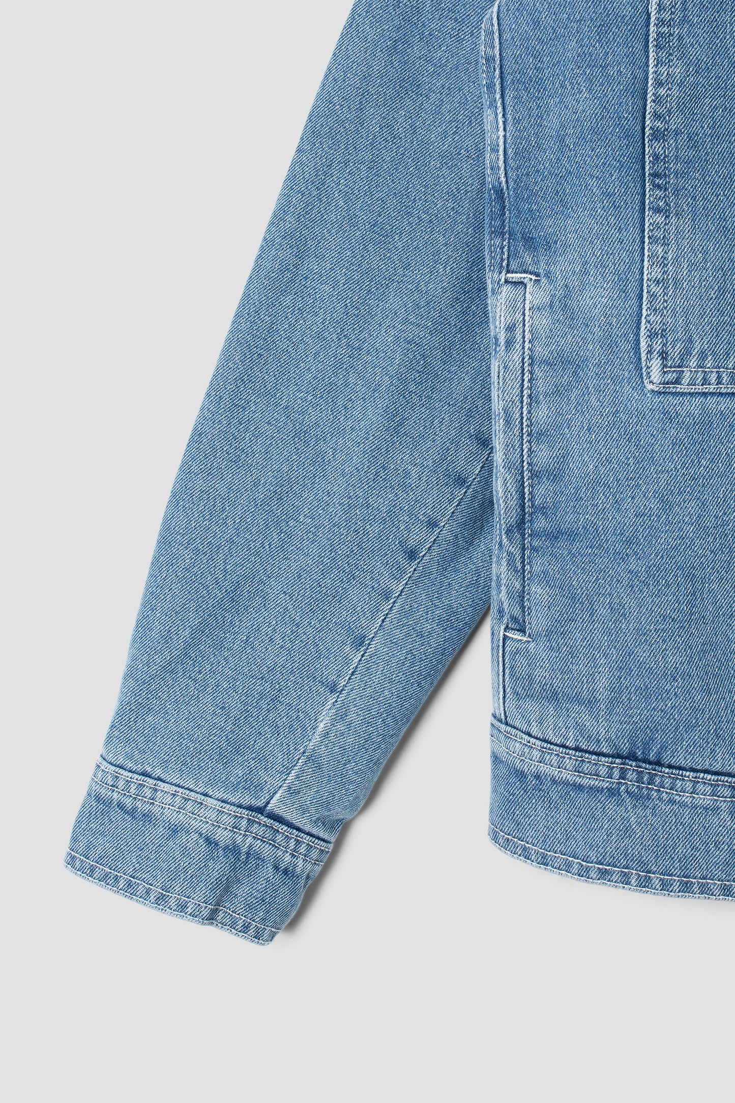 Sleeve detail of Stan Ray Trucker Jacket in stone wash denim.