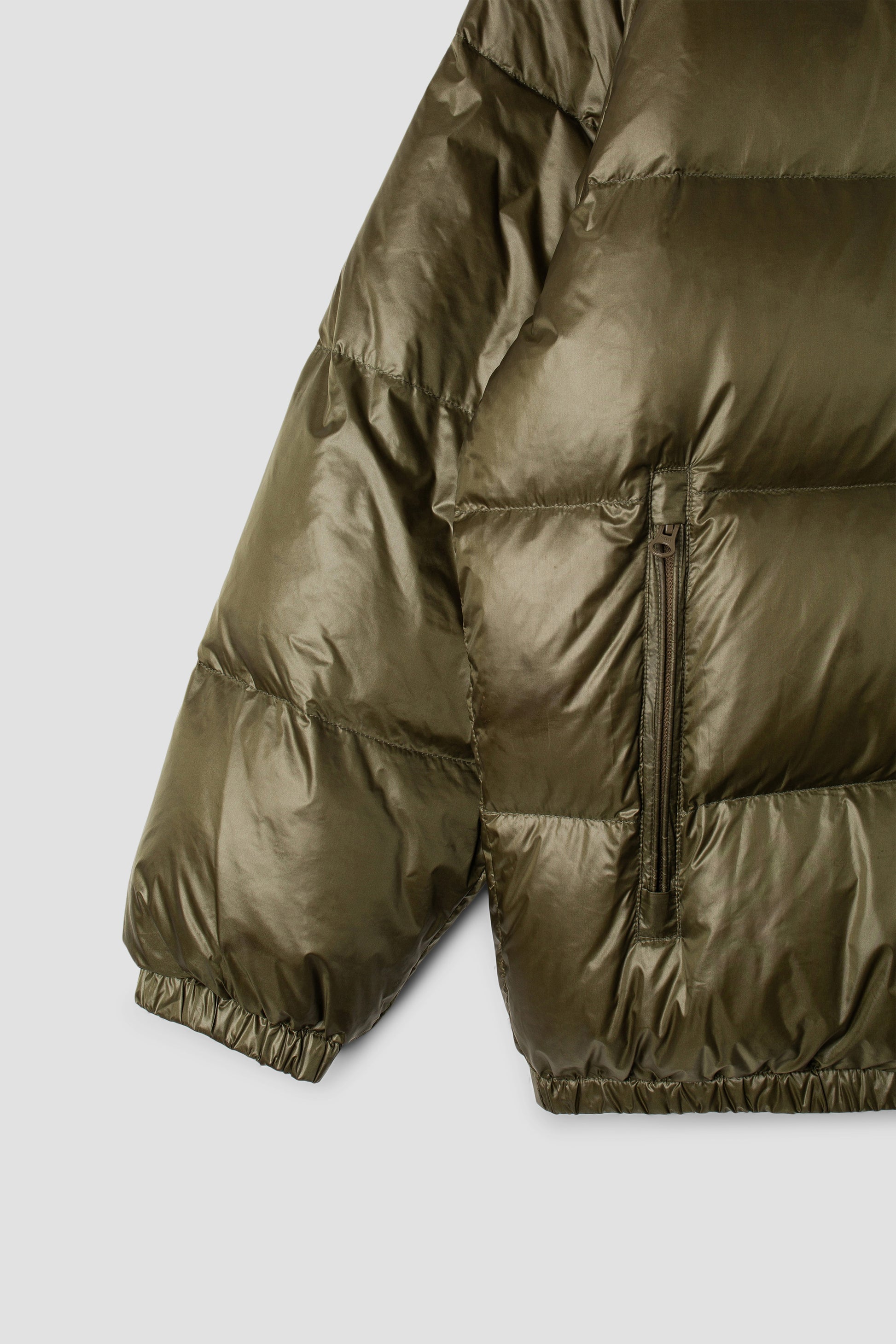 Close-up of olive parka sleeve and pocket detail